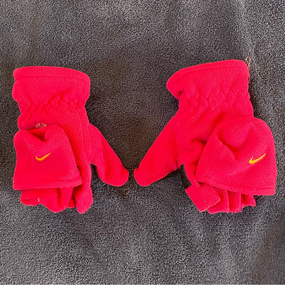 Pink Nike gloves that reveal the fingers for easy access.